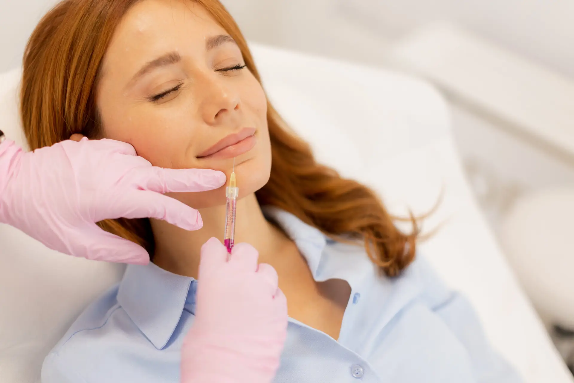 expertly enhancing beauty through lip filler treatment in a serene clinic setting