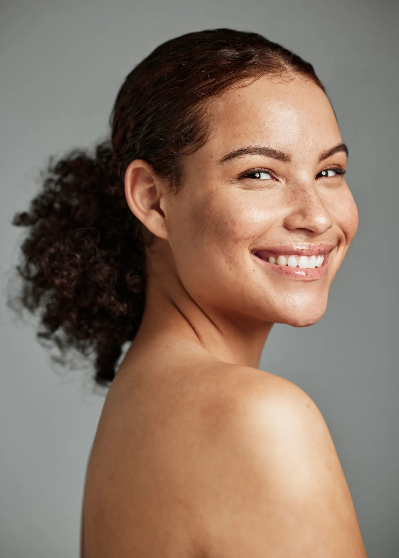 portrait, face and skin with a model black woman in studio on a gray background for beauty or skincare. facial, wellness and natural with an attractive young female posing to promote cosmetics
